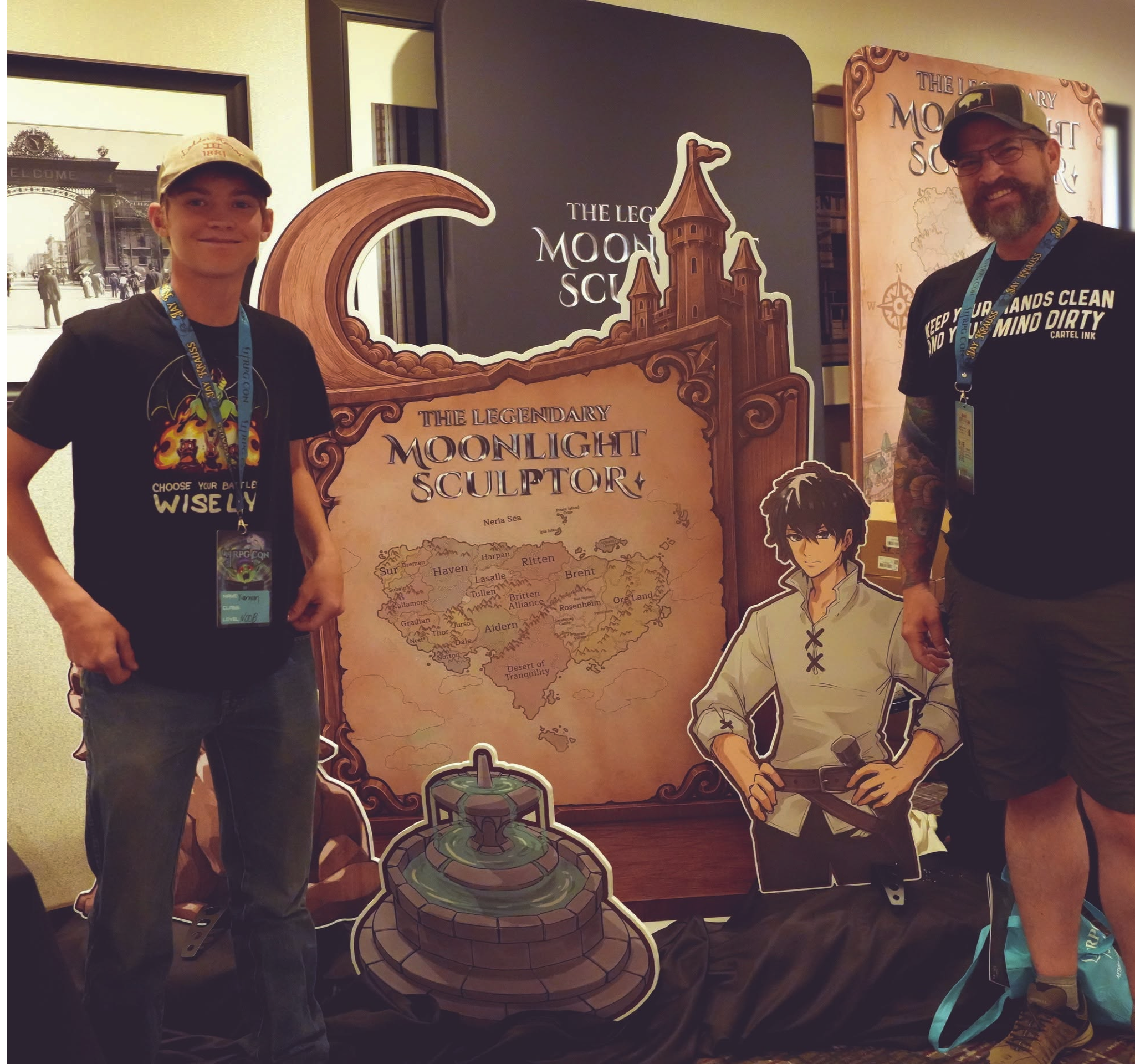 Two men standing in front of a display piece for The Legendary Moonlight Sculptor at LitRPG Con